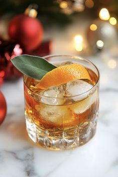 an orange slice on top of a glass with ice