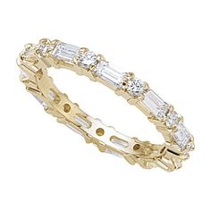 a yellow gold ring with baguetts and diamonds