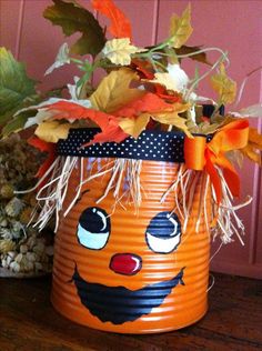 an orange pumpkin decorated with leaves and bows