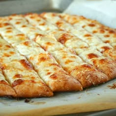 a pizza sitting on top of a pan covered in cheese