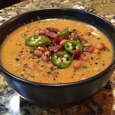 a bowl of soup with bacon, beans and jalapenos