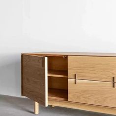 the sideboard is made from wood and has two doors on one side, and three drawers on the other