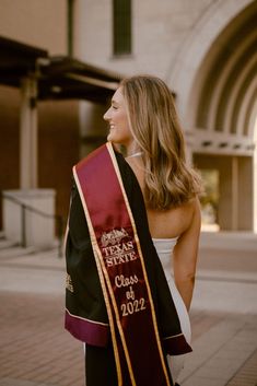 a woman wearing a black and red graduation stole with the words texas state class of 2012 on it