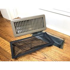 an air vent sitting on top of a wooden floor