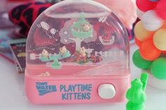 a toy water play time kit with gummy bears and other toys in the background