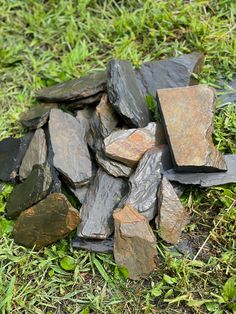 a pile of rocks sitting in the grass