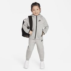 Made of bonded jersey knit fabric, this 2-piece set is inspired by the classic warmup suit. The hoodie has a full-zip closure that makes layering easy, and the matching tapered pants have ribbed cuffs and an elasticized waistband for a comfy fit the smallest athletes can play freely in. Fleece Sewing Projects, Nike Sportswear Tech Fleece, Kids Sportswear, Baby Nike, Sewing Fleece, Hoodie Set, Nike Tech Fleece, Toddler Hoodie, Nike Tech