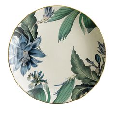 a white plate with blue flowers and green leaves