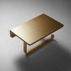 a gold coffee table on a grey background