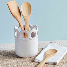 wooden utensils and spoons in a white container