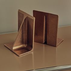 two pieces of metal sitting on top of a table