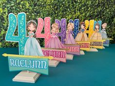 there are many wooden signs that say the number four and have princesses on them