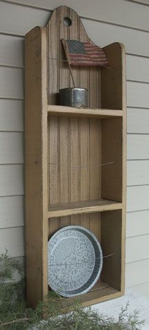 a wooden shelf with an american flag on top and a plate in the bottom section