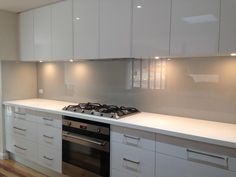 a kitchen with white cabinets and an oven