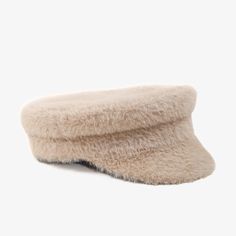 a white hat that is on top of a table and it has a fur lining around the brim