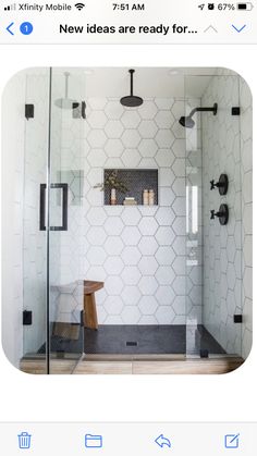 an instagramted photo of a bathroom with hexagon tiles and wood accents