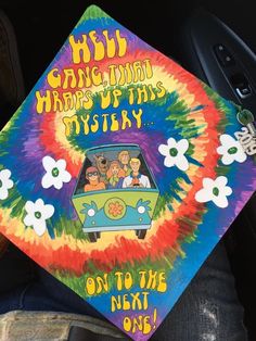 a colorful tie dye graduation cap with the words, happy birthday mystery on it