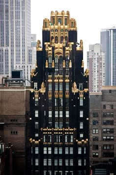 a very tall building with lots of windows and gold decorations on it's side