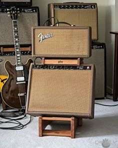 guitars and amps are stacked on top of each other