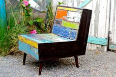 an old wooden chair with colorful paint on it