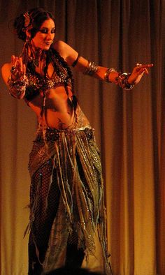 a belly dancer is performing on stage