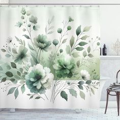 a shower curtain with flowers and leaves painted on it in a white bathroom, next to a bathtub