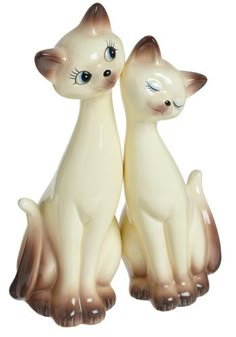 two ceramic cats sitting next to each other