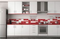 a kitchen with red and white tiles on the walls, cabinets and appliances in it