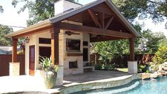 a pool house with a covered patio next to it and a hot tub in the middle