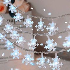 snowflake lights are hanging from a string