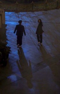 two people walking in the rain at night