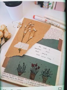 an open book with flowers and writing on it