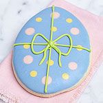 a decorated cookie sitting on top of a pink napkin