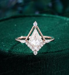 an engagement ring in gold with a white topazte and diamonds on the side