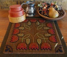 a wooden table topped with a bowl of fruit and a plate of food on top of it