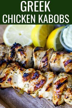 grilled chicken kabobs on a cutting board with lemon wedges