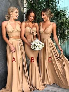 three bridesmaids in long dresses standing next to each other