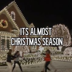 people are dancing in front of christmas lights and houses with the words it's almost christmas season