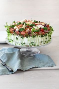 a large cake sitting on top of a table next to a plate with silverware