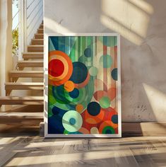 an abstract painting on the wall in front of some stairs with sunlight coming through it