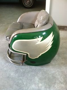 a green and white football helmet shaped chair