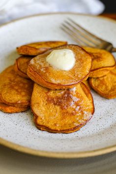 Sweet potato pancakes with a dollop of butter on a plate