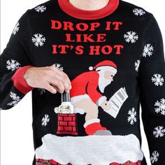 a man wearing an ugly sweater with santa clause on it holding a wine bottle in his hand