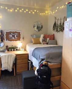 a dorm room with a bed, desk and chair