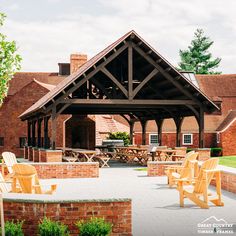 an outdoor patio with wooden chairs and tables