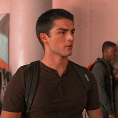 a man in a brown shirt and black backpack