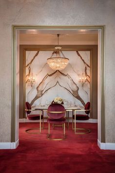 A luxurious dining room with a marble-textured accent wall and crystal chandeliers. Wall Inspiration, Luxury Dining Room