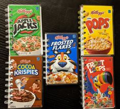 three notebooks with cereal on them sitting next to each other