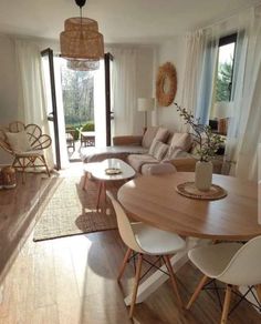 a living room filled with furniture and a wooden table in front of a sliding glass door