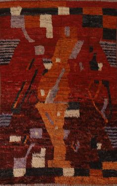 an orange and brown area rug with abstract designs on it's sides, including a stylized figure in the center